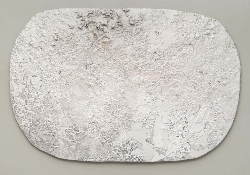 Textured white abstract wall sculpture by Lynn Basa titled Smatterings (2023), measuring 45 x 68 x 1.5 inches. The irregularly shaped form features layered, and organic surface patterns
